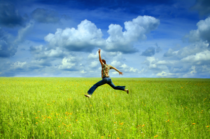 man happily running thru field